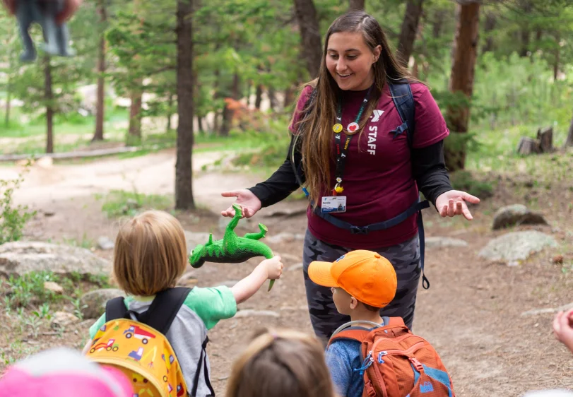 Staff smiling with little kids outsite