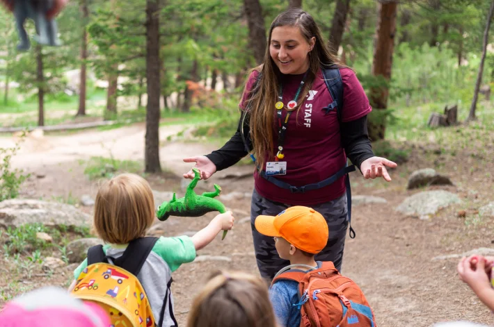 Staff smiling with little kids outsite